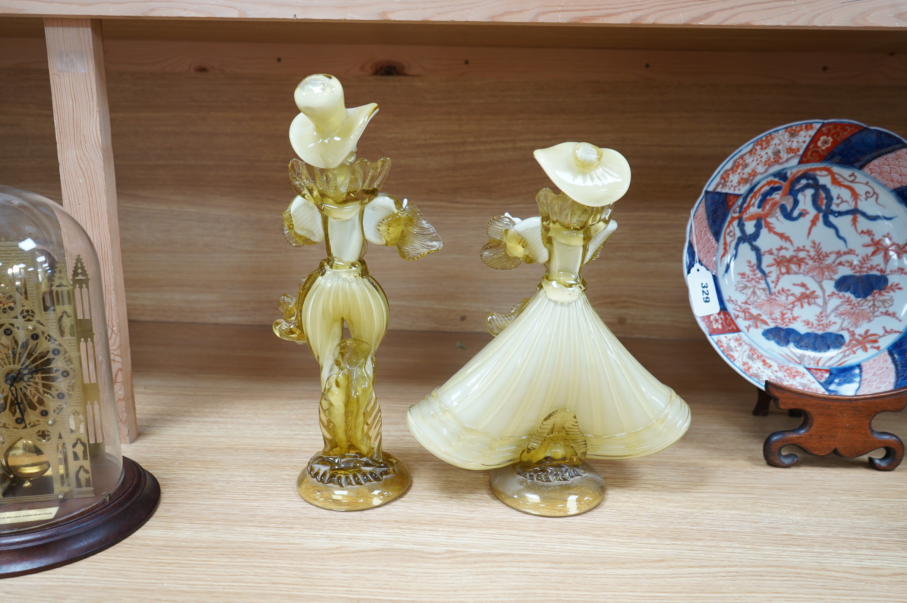 A pair of Murano amber and cream glass figures, tallest 38cm high. Condition - good